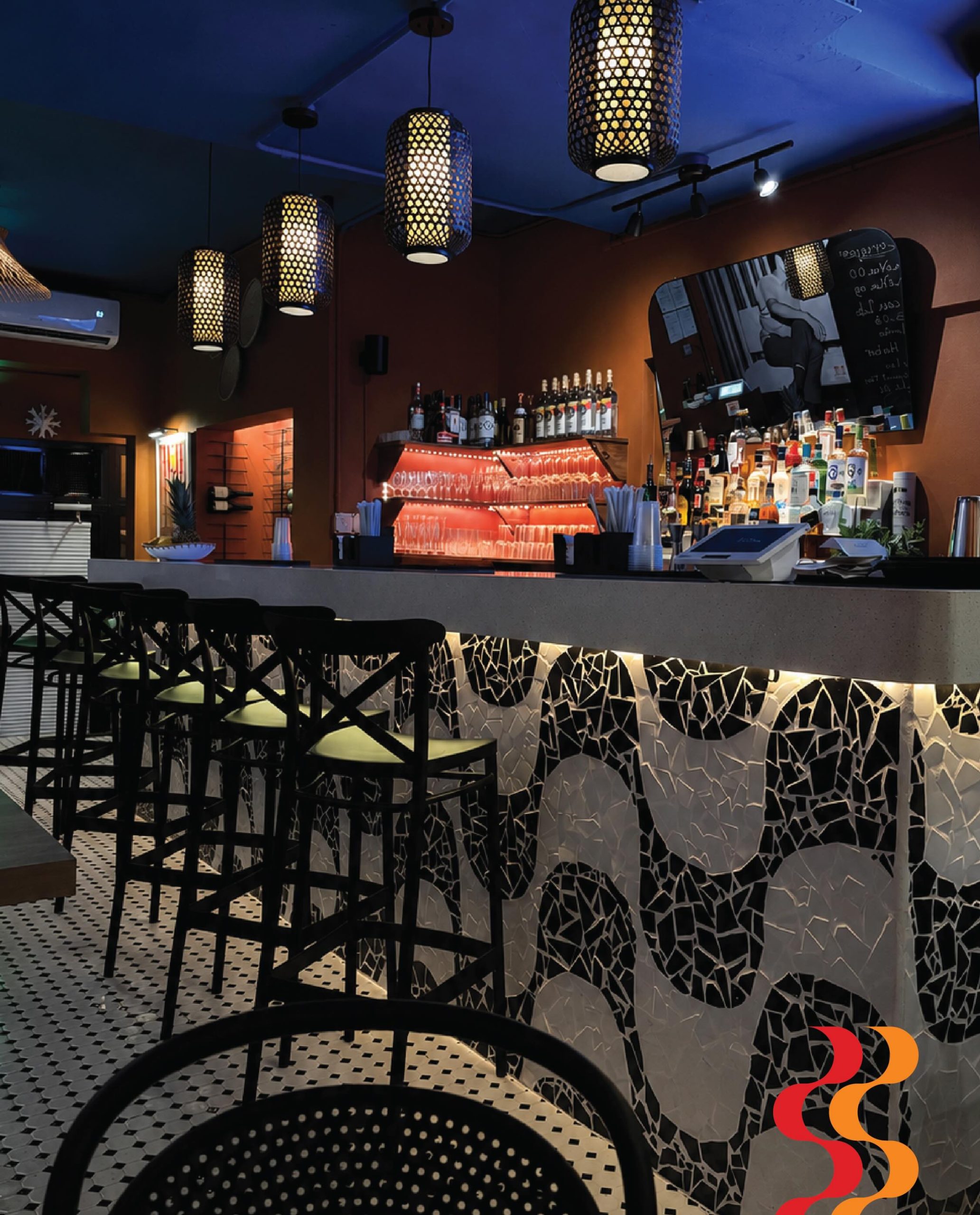 Bossa Nova's bar with mosaics, pendant lights and a warm atmosphere
